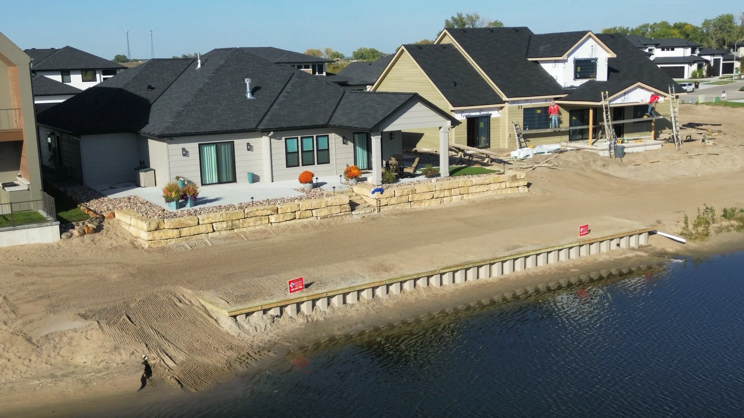 Boulder retaining wall and beach on a Nebraska sandpit lake