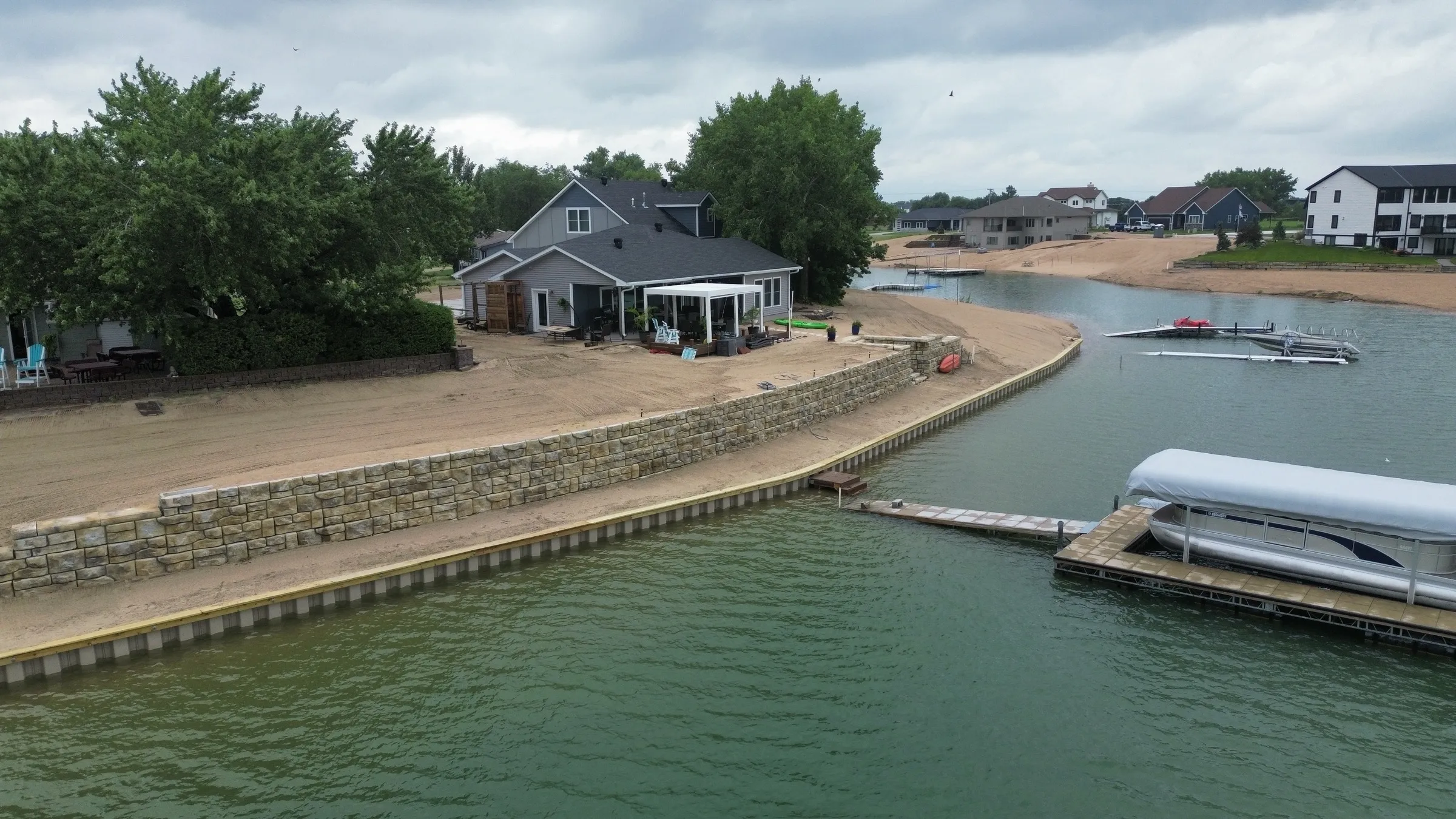 Steel seawall and new sand beach on a Southeast Nebraska lake by Outback Construction
